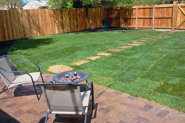 backyard with sod and fence